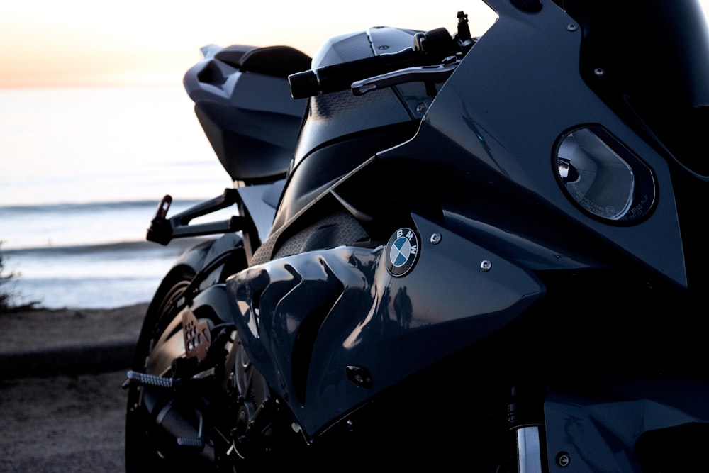 a motorcycle parked on the side of a road near the ocean
