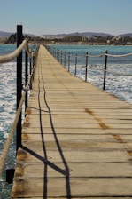 a long dock with a rope on the end of it