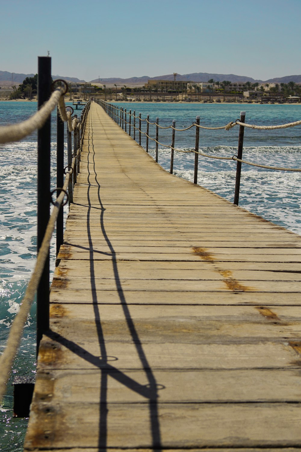 a long dock with a rope on the end of it