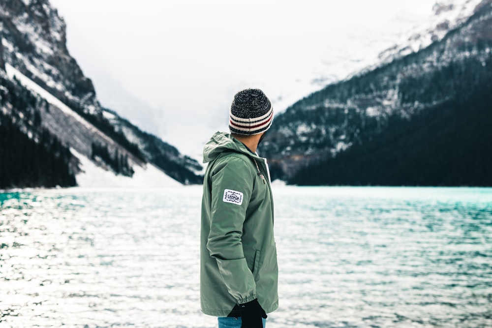 a man standing in front of a body of water