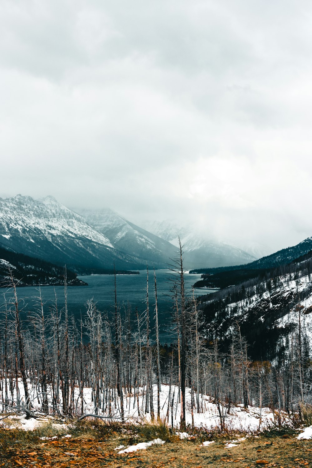 a view of a mountain range with a lake in the foreground