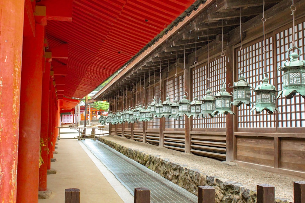 a line of lanterns hanging from the ceiling of a building