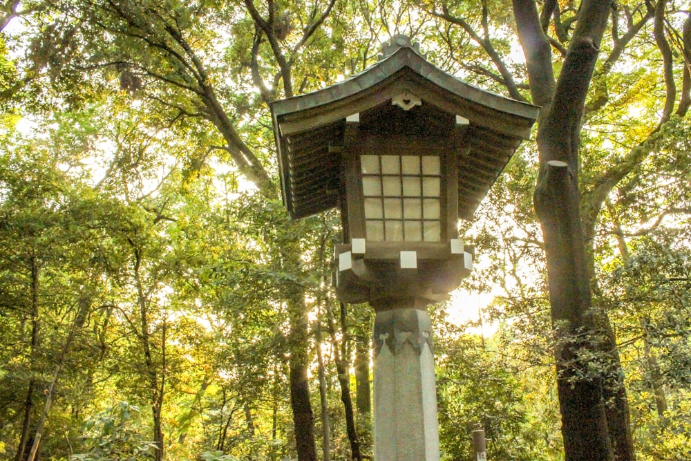 a small tower in the middle of a forest