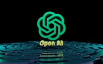 A stylized, green geometric logo resembling overlapping lines forms the central focus. Below the logo, the text 'Open AI' is displayed in a golden hue. The background features a pattern of concentric, reflective circles with a teal tint on a dark surface.