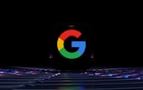 a close up of a computer keyboard with the google logo on it