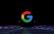 a close up of a computer keyboard with the google logo on it