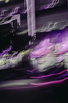 Soft neon blue and purple lights blending into a dark cityscape silhouette.