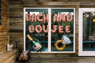 a sign that says bach and boulee in front of a window