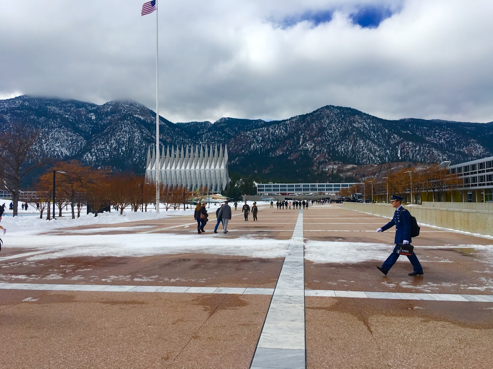 a group of people walking across a snow covered field