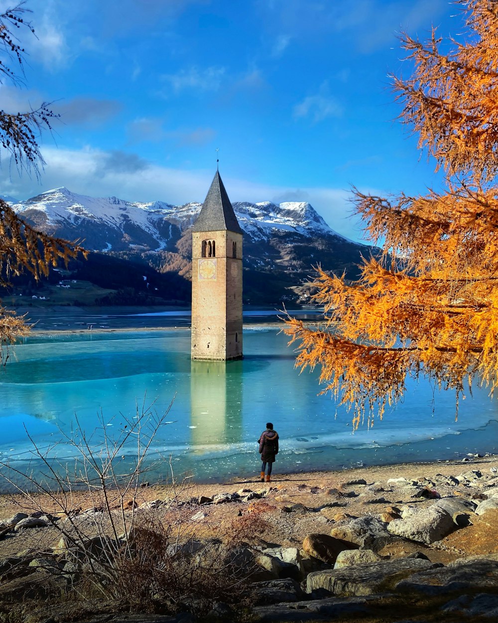 a person standing in front of a body of water