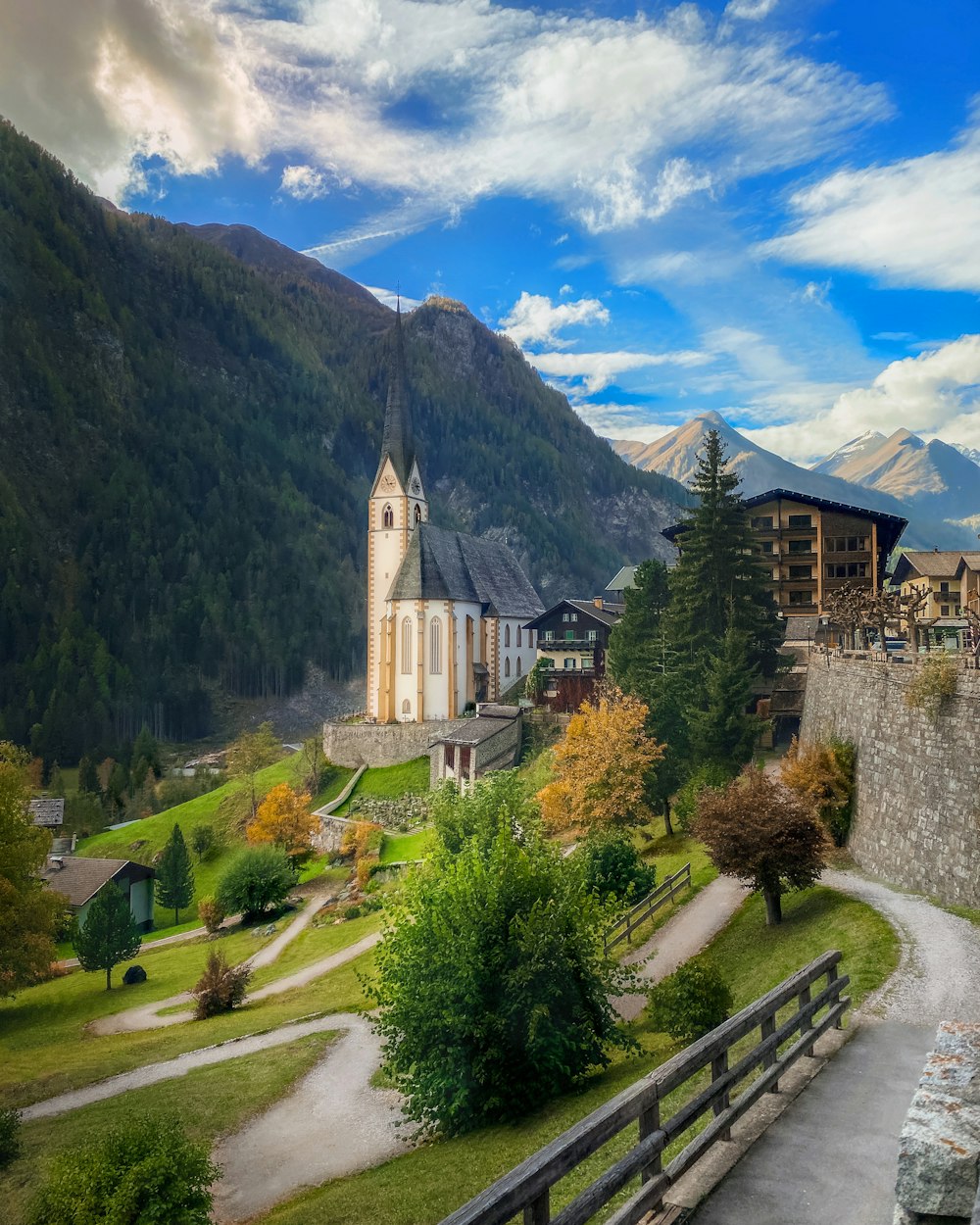 a church in the middle of a lush green valley