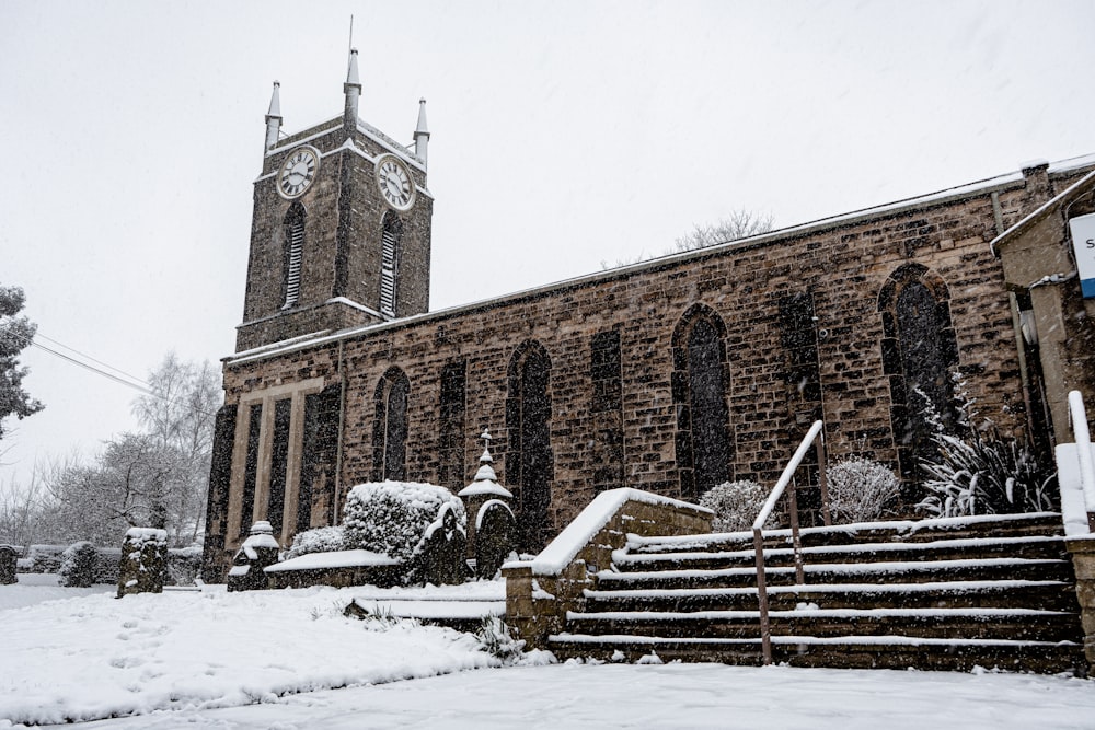 a church with a steeple covered in snow