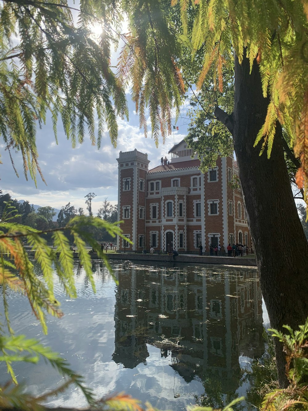 a large brick building sitting next to a body of water