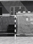 Close-up of a coach passionately giving instructions in a modern indoor futsal venue.