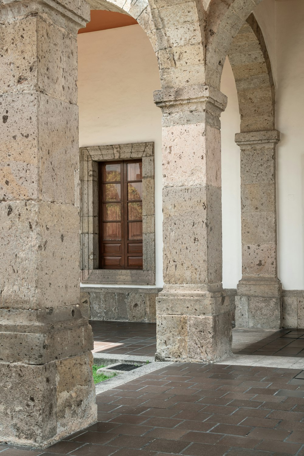 a stone building with columns and a door