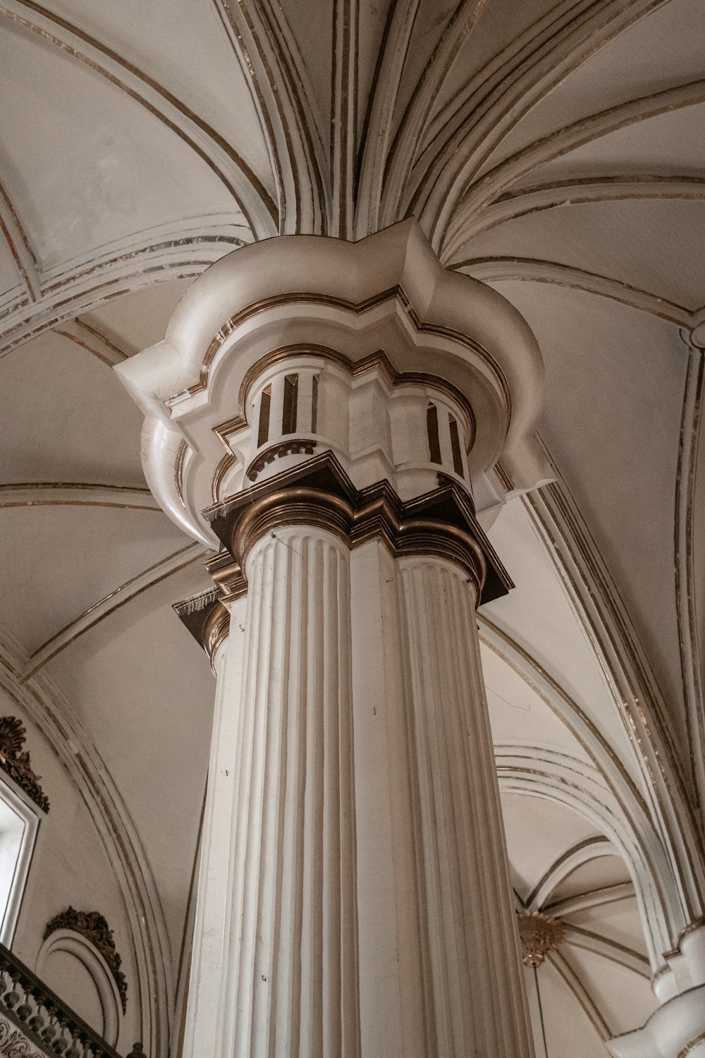 a column in a building with a clock on it