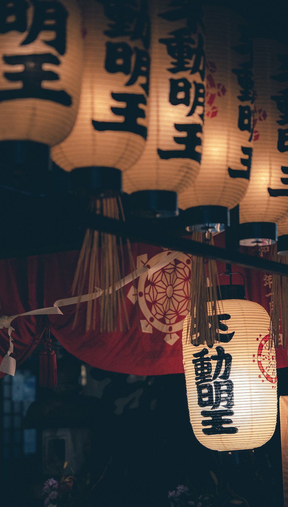 a group of chinese lanterns hanging from a ceiling