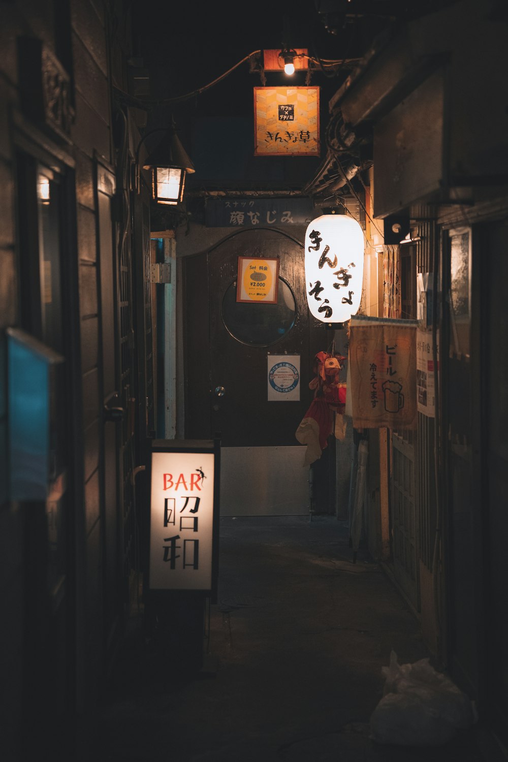 a narrow alley way with a sign on the side of it