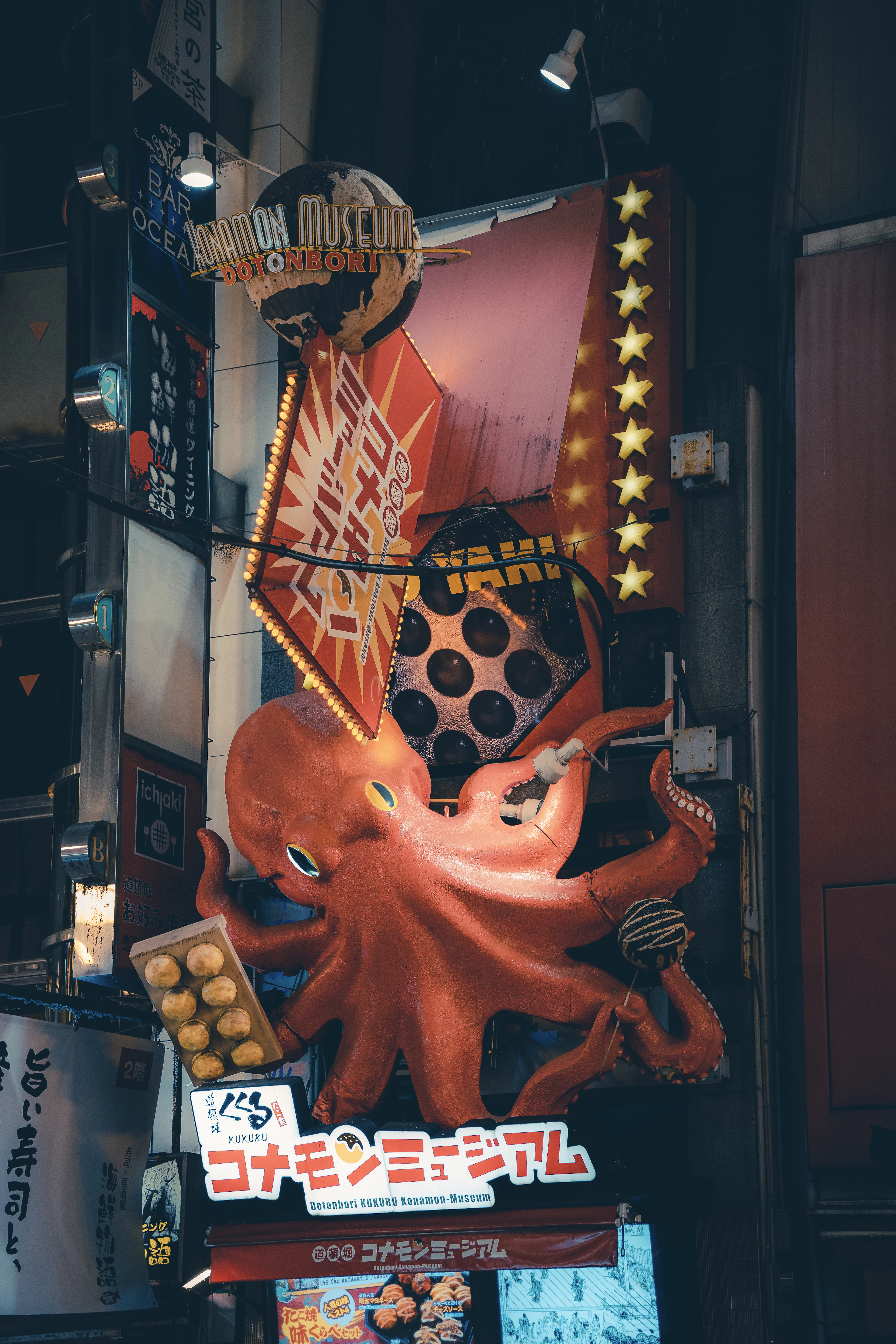 The giant red octopus sculpture over the entrance of the Konamon Museum, a takoyaki shop in Osaka's Dotonbori