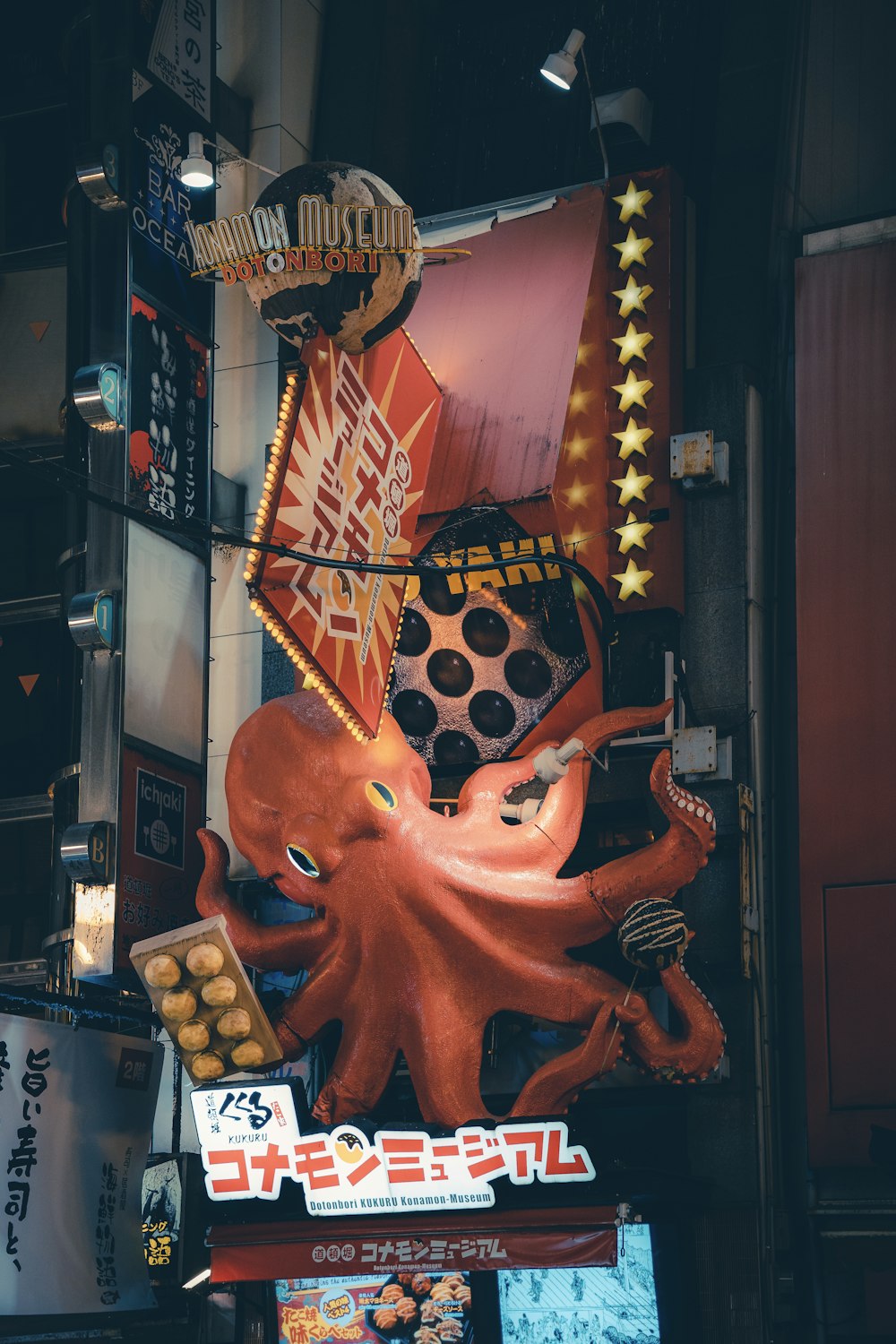 a large octopus sign hanging from the side of a building