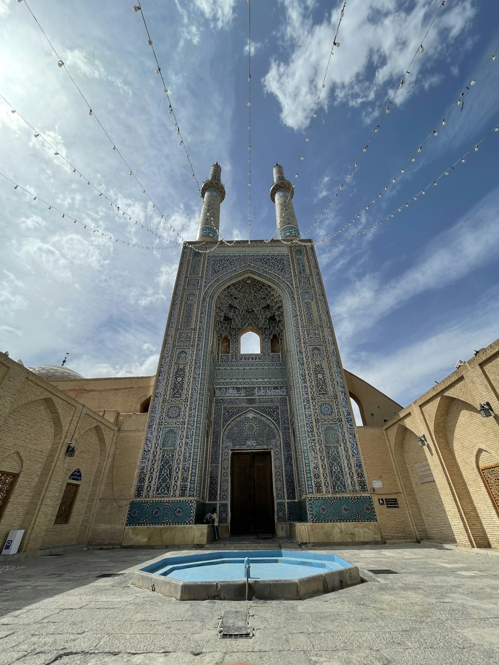 a large building with a fountain in front of it