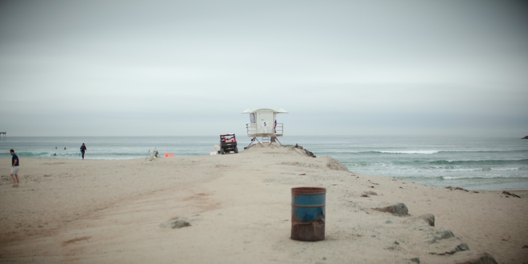 a lifeguard chair sitting on top of a sandy beach