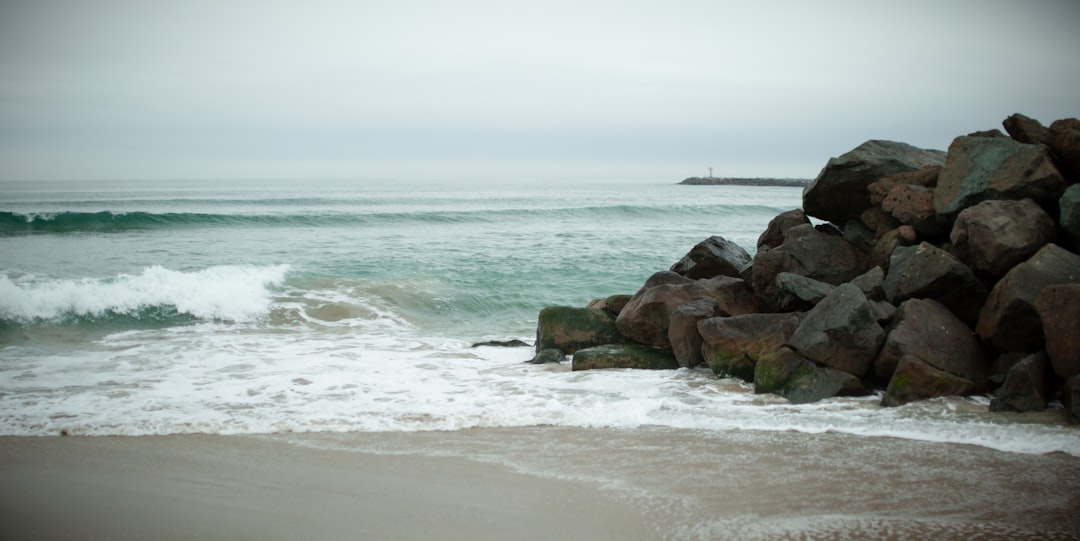 a rocky beach with waves coming in to shore