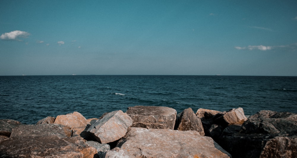 a view of a body of water with rocks in the foreground