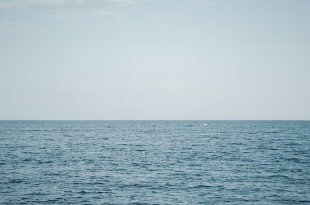 a lone boat in the middle of the ocean