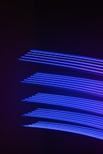 a dark background with blue lines in the middle of it
