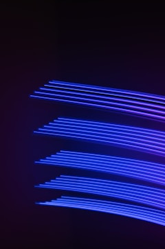 a dark background with blue lines in the middle of it