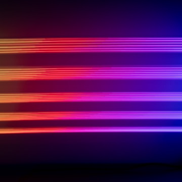 A sleek futuristic TV commercial set glowing with neon blue and violet lights.