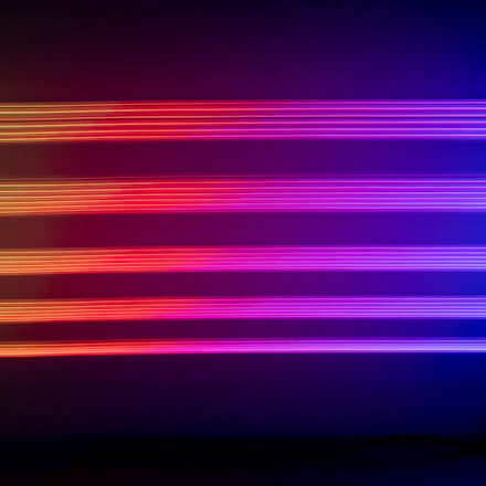 A sleek horizontal scroll of glowing neon cards over a deep violet gradient with floating 3D spheres.