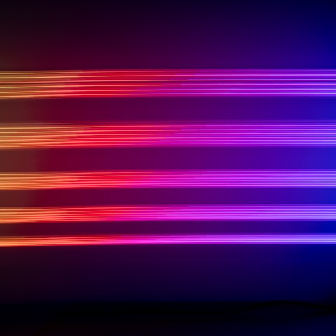 Portrait of the Viral Media creative team in a warm, low-key cinematic style with violet neon glow background.