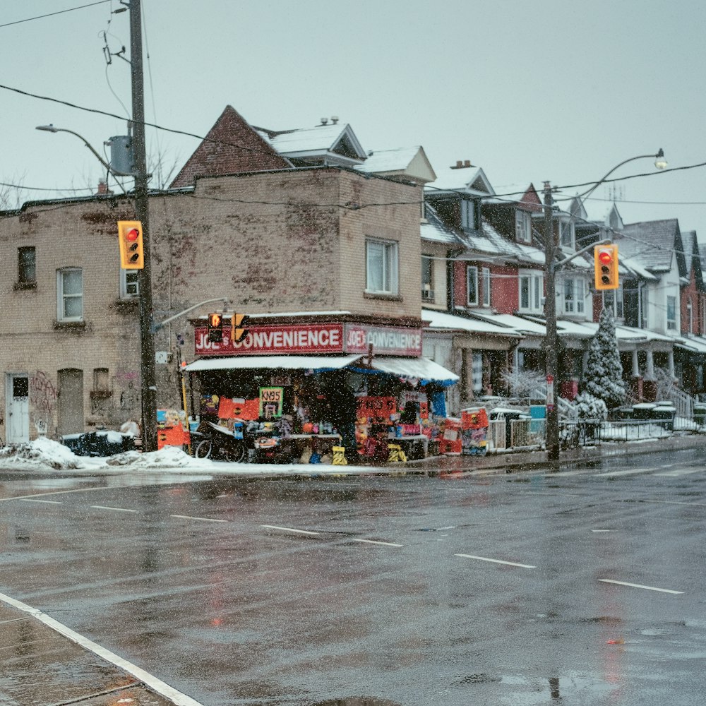 a street corner with a store on a snowy day