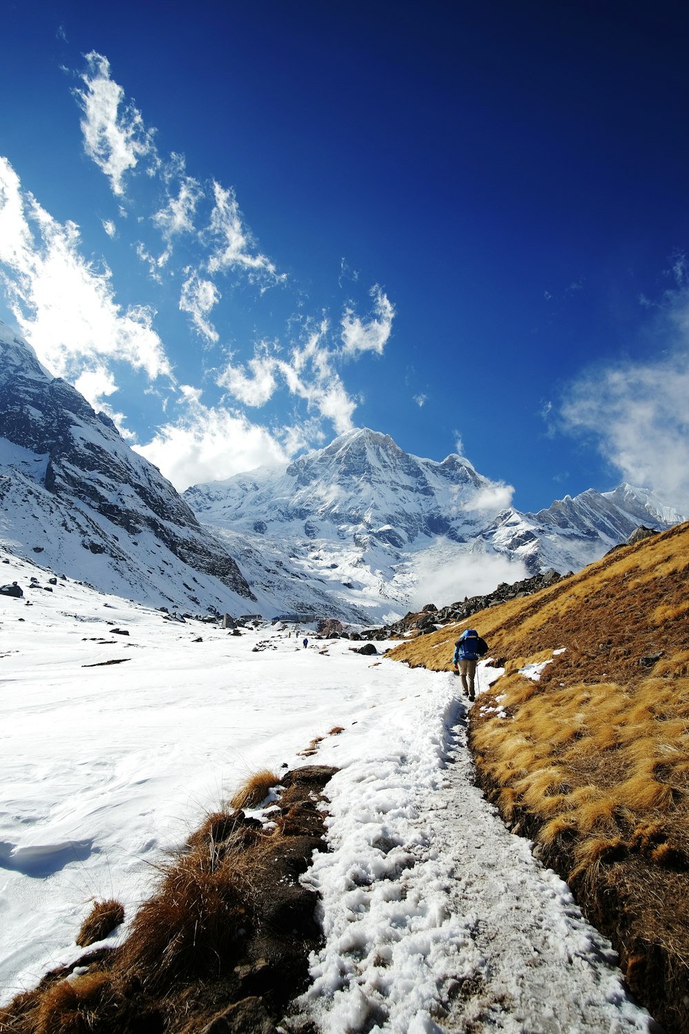 a man hiking up a snow covered hill