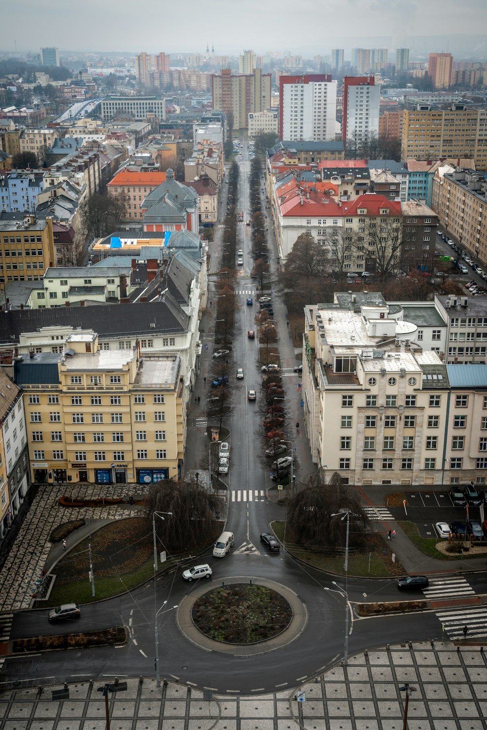 an aerial view of a city street with buildings in the background