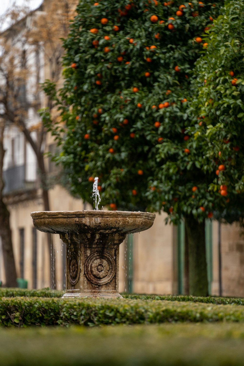 a small figurine sitting on top of a fountain