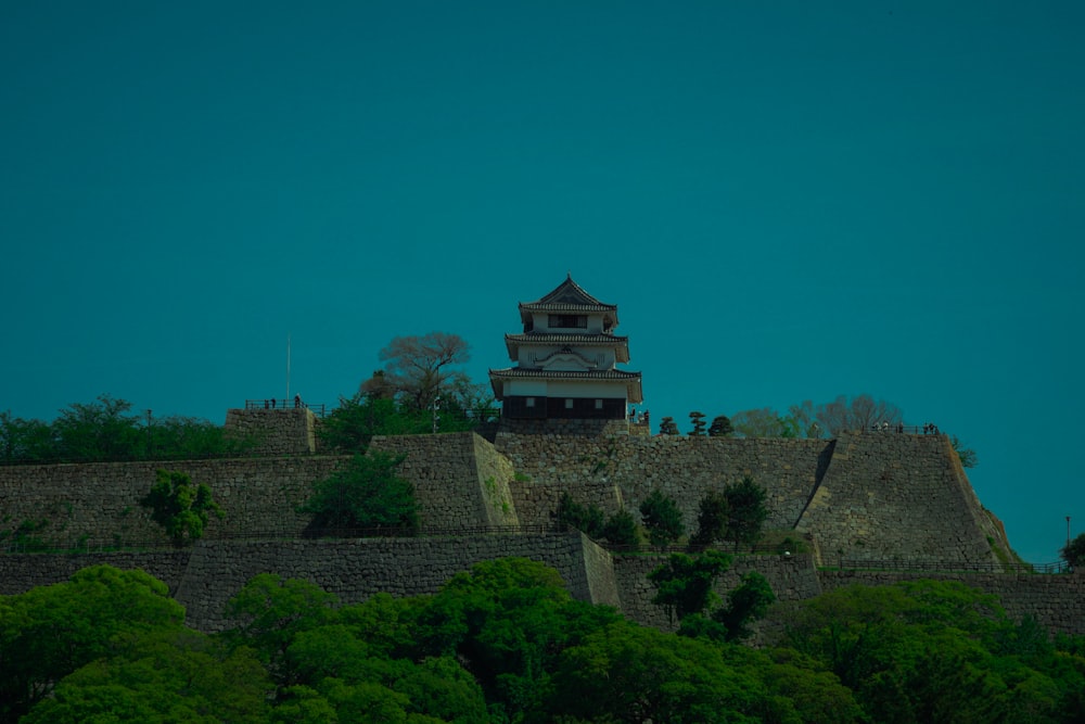 a tall tower sitting on top of a lush green hillside