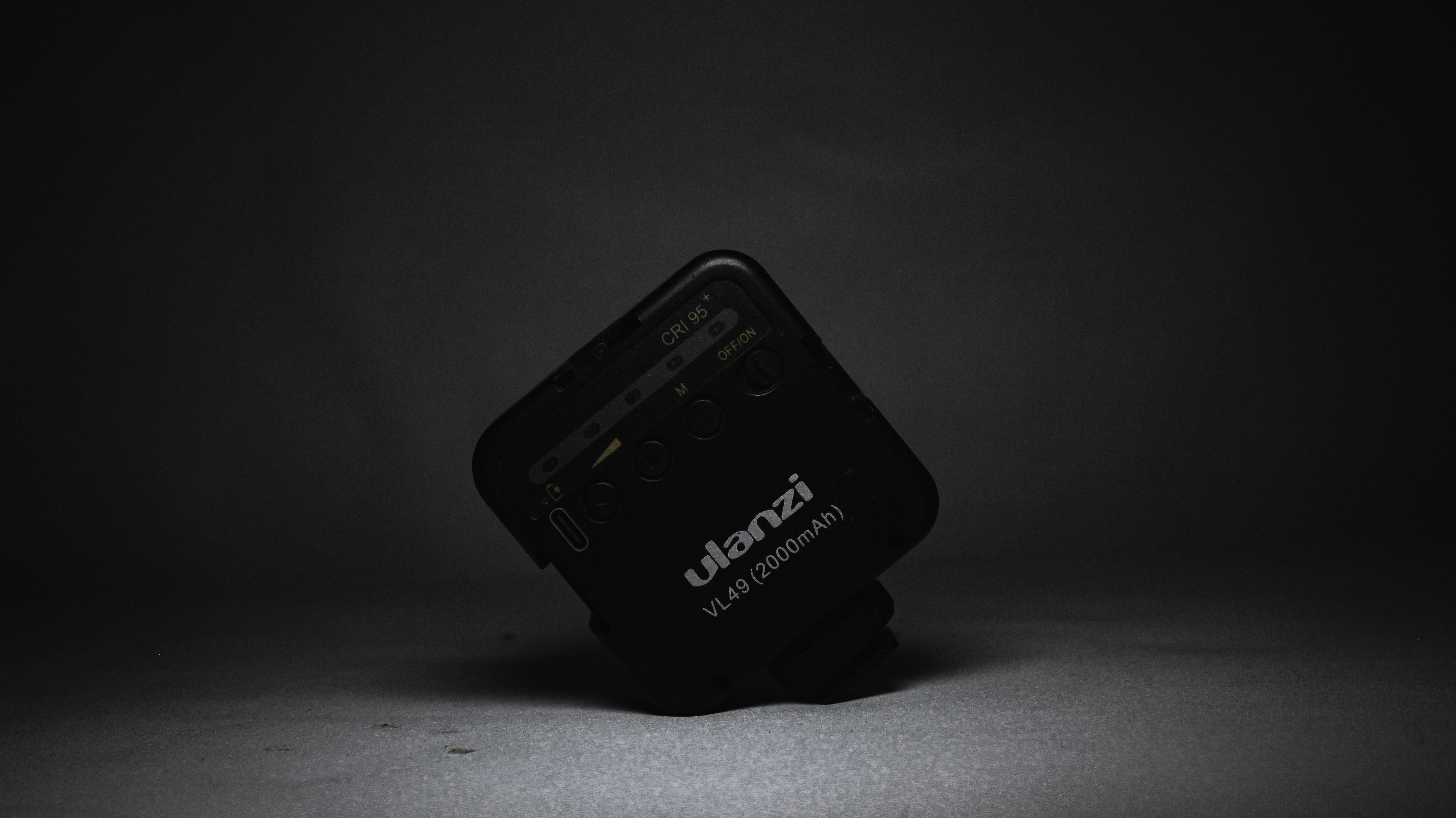 a cell phone sitting on top of a black stand