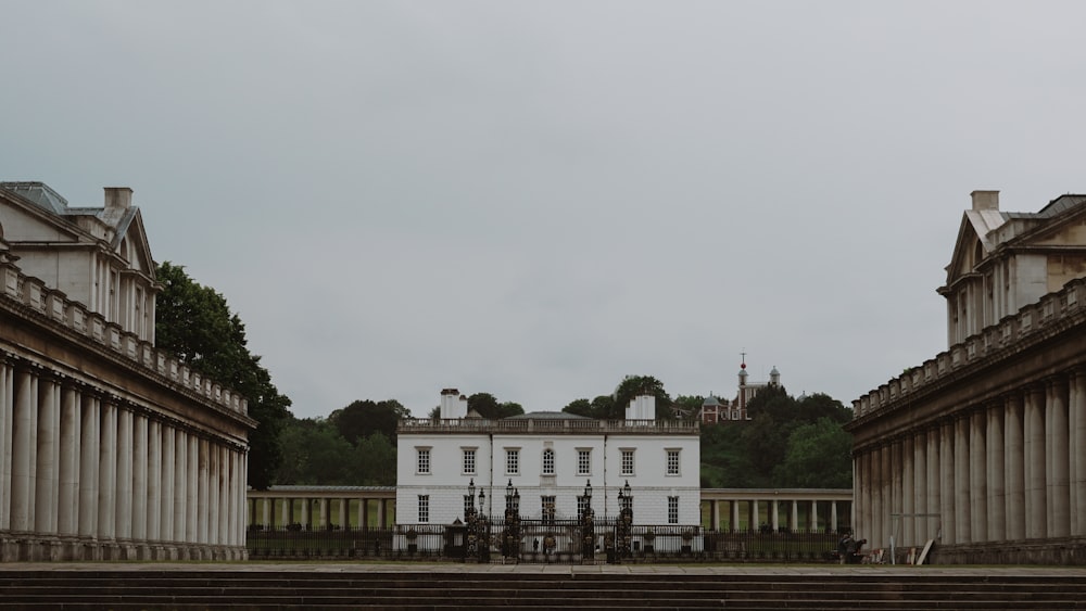 a large white building sitting next to a set of steps