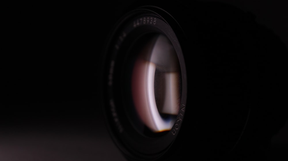 a close up of a camera lens in the dark