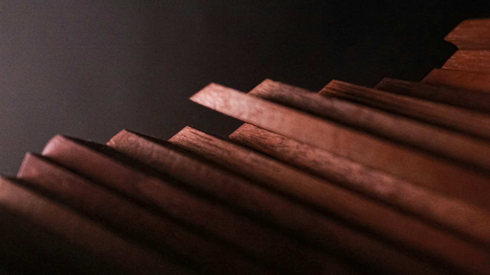 a close up of a wooden structure with a black background