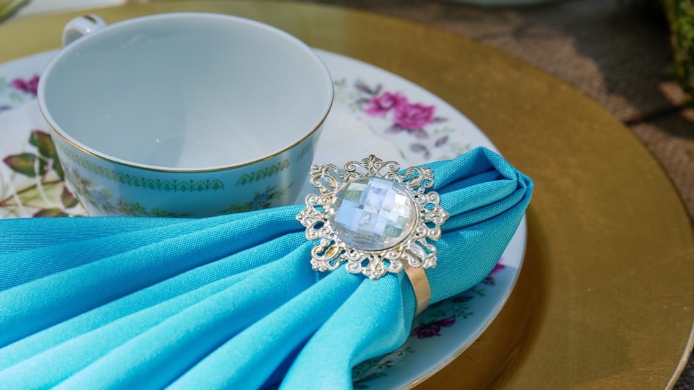 a blue napkin with a ring on top of it