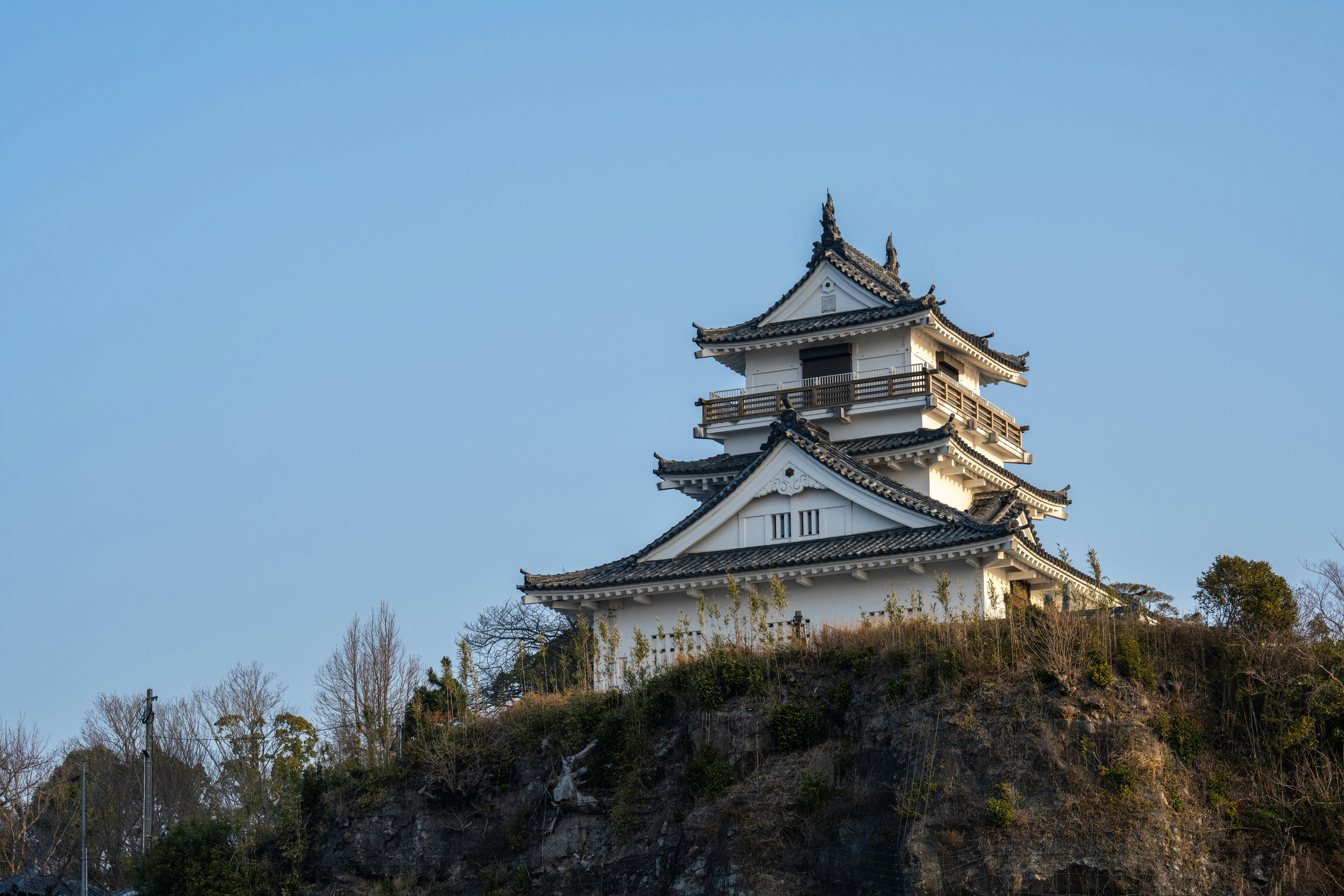 a tall white building sitting on top of a hill