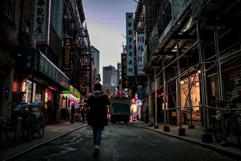 a person walking down a street in a city