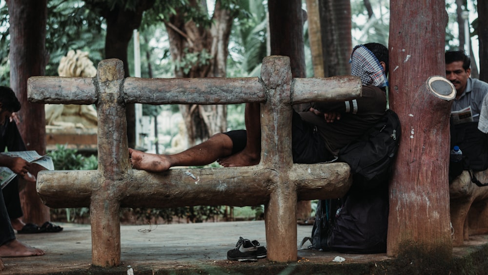 a group of people sitting on a wooden bench