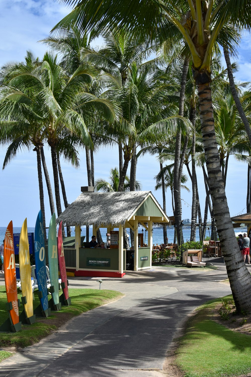 a small pavilion with surfboards on the side of the road