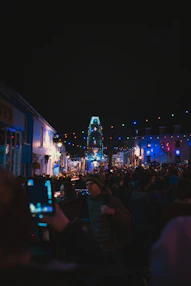 A lively street scene in Sumter with people enjoying a local festival under colorful lights.