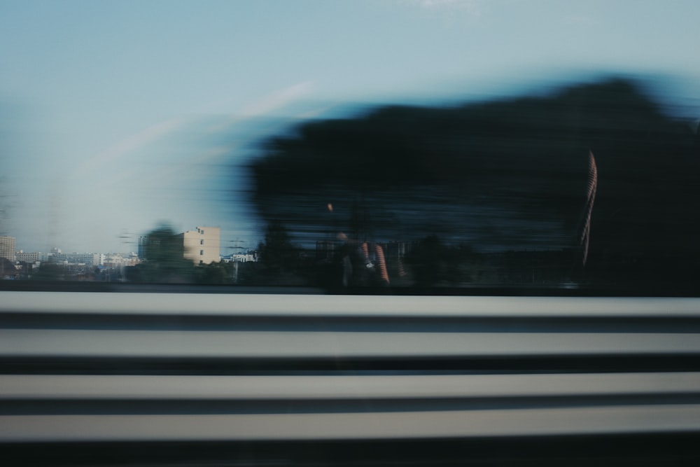 a blurry photo of a city skyline taken from a moving train